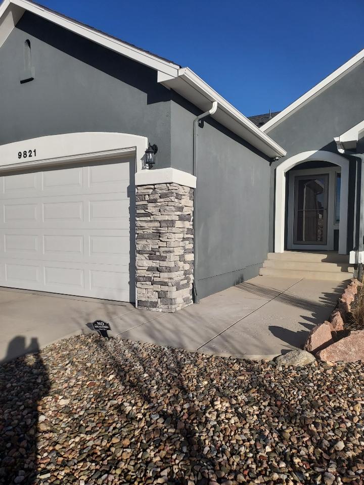 Residential stucco home with stone column accent